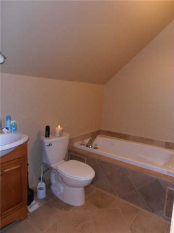 1568 Camp Ravine Road Burns, TN 37029 - Photo 17 of 20 a white toilet sitting next to a bath tub