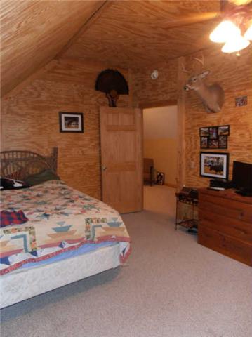 1568 Camp Ravine Road Burns, TN 37029 - Photo 18 of 20 a bedroom with a bed and a tv