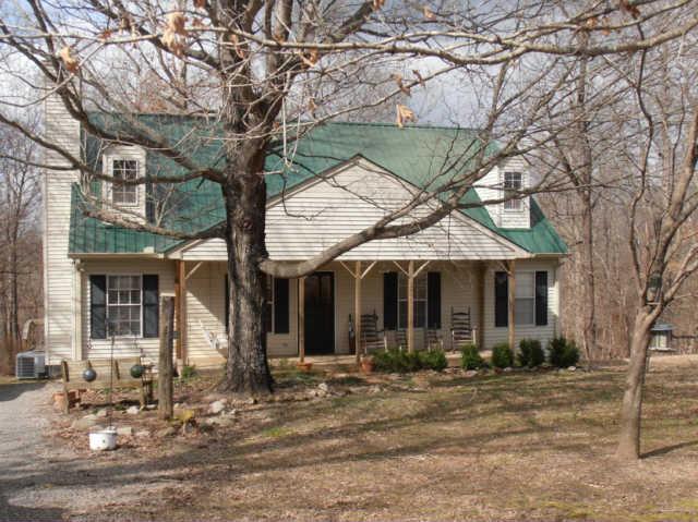 1568 Camp Ravine Road Burns, TN 37029 - Photo 2 of 20 a front view of a house with a yard