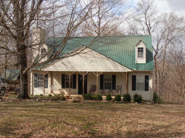 1568 Camp Ravine Road Burns, TN 37029 - Photo 3 of 20 a front view of a house with garden