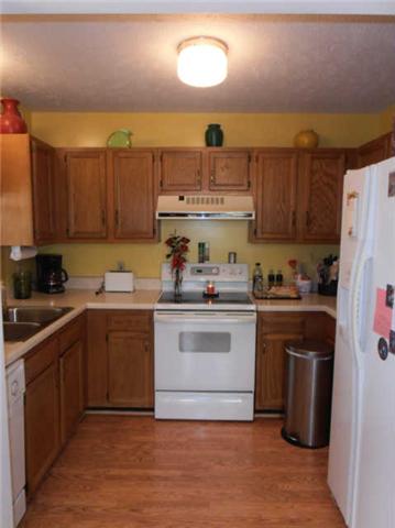 1568 Camp Ravine Road Burns, TN 37029 - Photo 10 of 20 a kitchen with a sink cabinets and stainless steel appliances