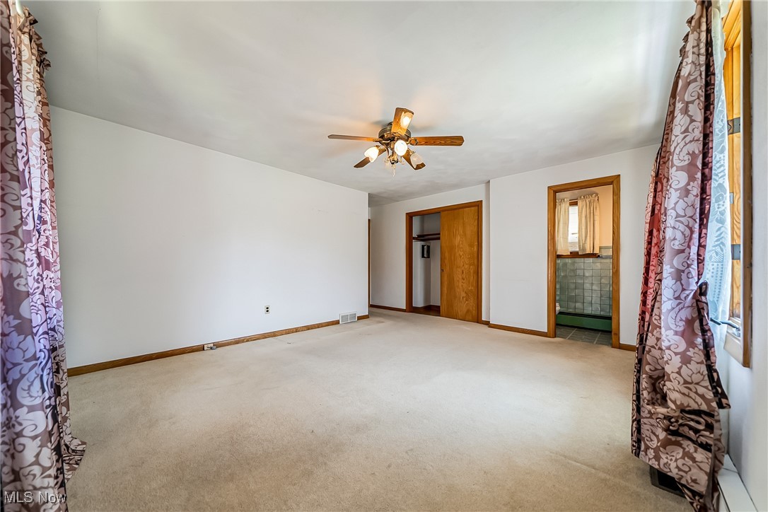 550 Cooper Foster Park Road Lorain, OH 44053 - Photo 22 of 50 Unfurnished bedroom with light colored carpet, ceiling fan, and a baseboard heating unit