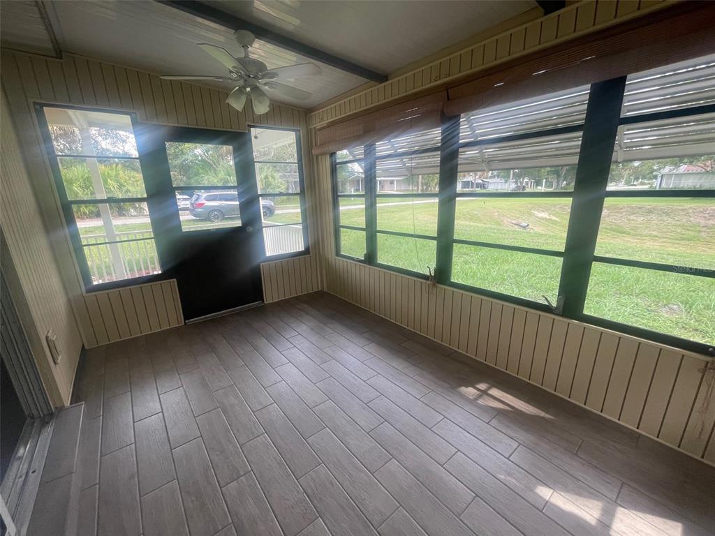 10028 Southwest 88th Terrace Ocala, FL 34481 - Photo 18 of 22 a view of an empty room with wooden floor and a window