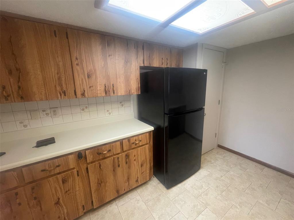 10028 Southwest 88th Terrace Ocala, FL 34481 - Photo 3 of 22 a kitchen with stainless steel appliances a refrigerator and a sink
