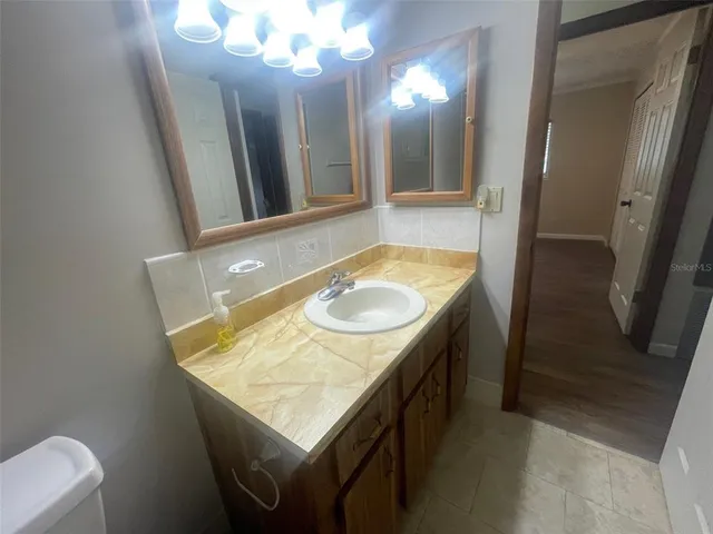 a bathroom with a sink a vanity and a mirror