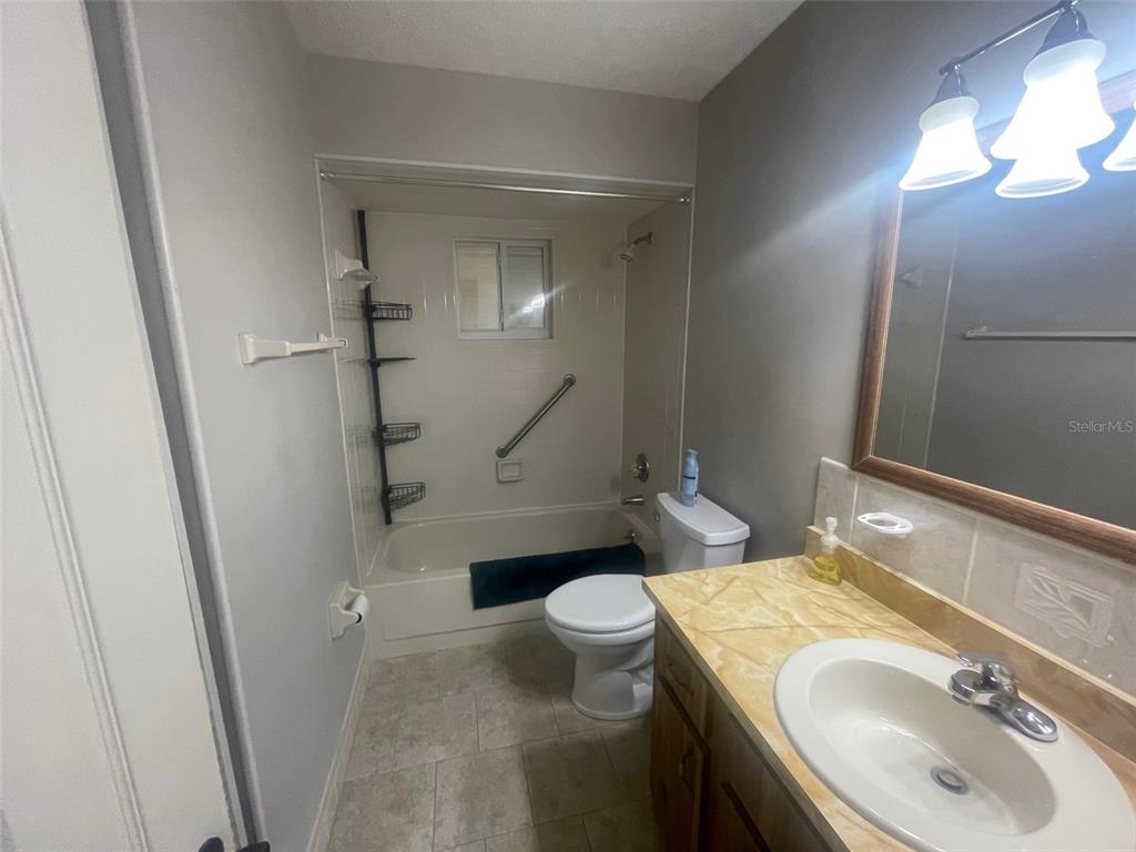 10028 Southwest 88th Terrace Ocala, FL 34481 - Photo 10 of 22 a bathroom with a sink toilet and shower