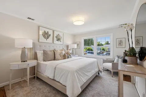 a bedroom with a bed and a lamp