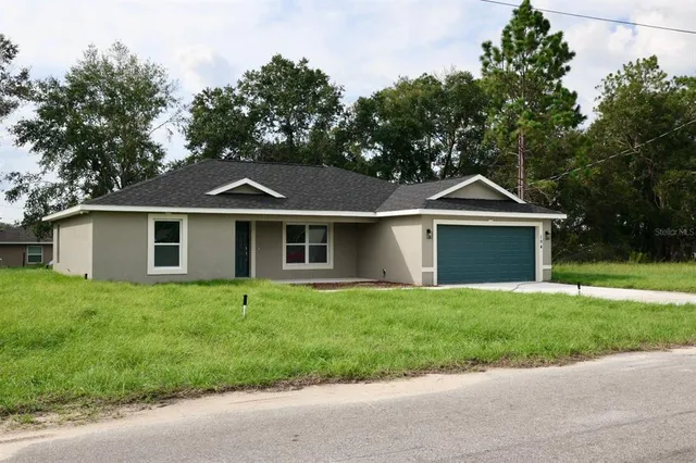 a view of a kitchen center island with wooden floor and staircase