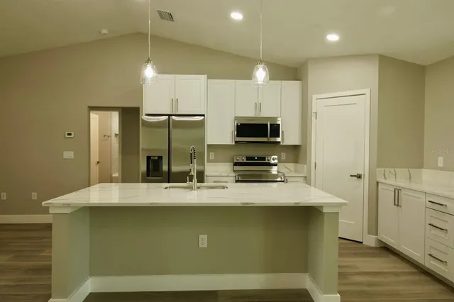 a view of a kitchen with a sink and cabinet