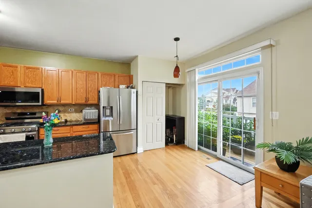 a kitchen with stainless steel appliances granite countertop a refrigerator and a sink