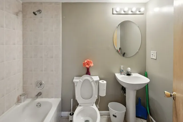 a bathroom with a sink mirror toilet and bathtub