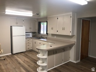 1615 Pioneer Road Draper, UT 84020 - Photo 9 of 13 Kitchen with wood-finish flooring, white cabinetry, light-toned countertops, and an integrated breakfast bar with open shelving