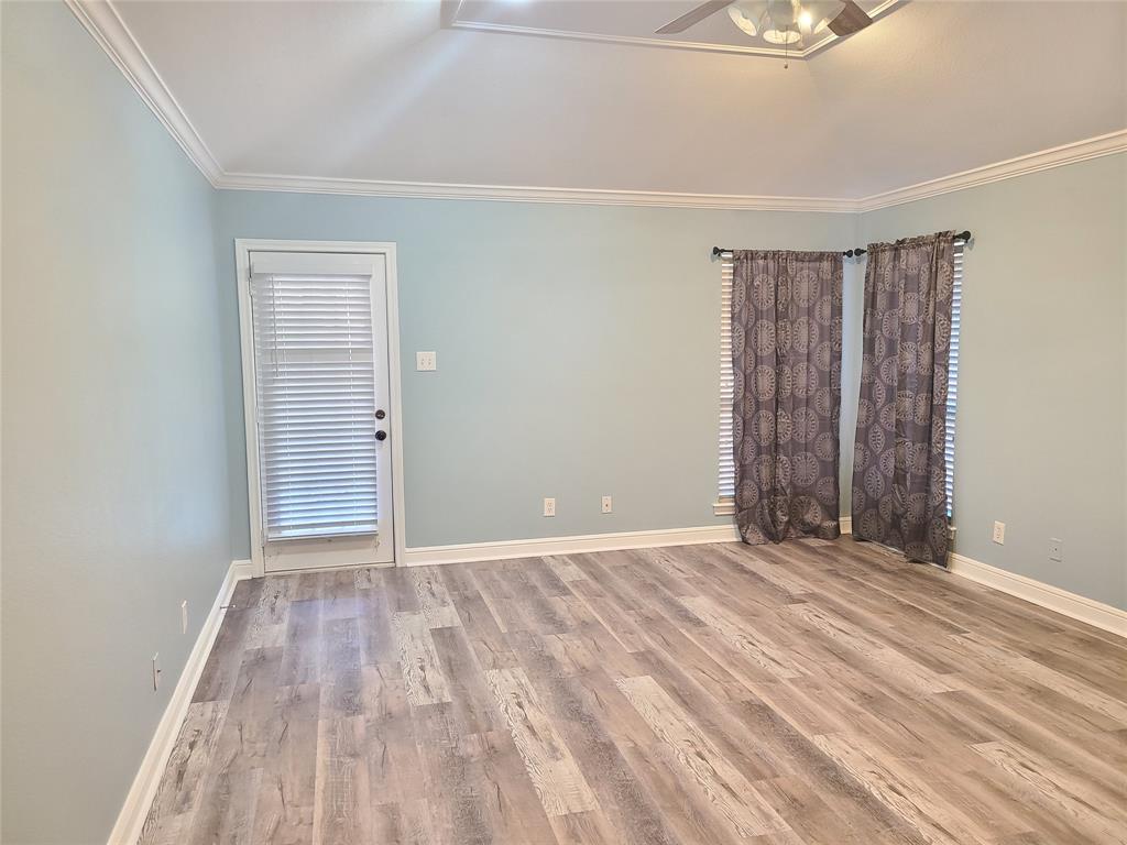 8921 Bontura Road Granbury, TX 76049 - Photo 13 of 26 a view of an empty room with wooden floor