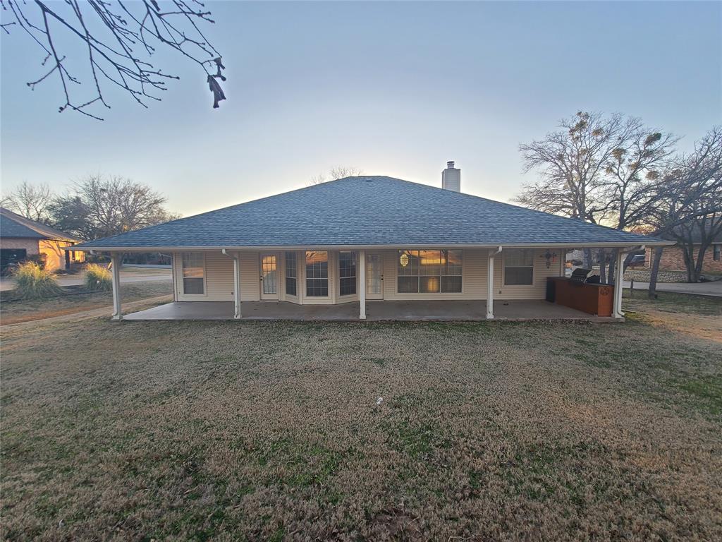 8921 Bontura Road Granbury, TX 76049 - Photo 24 of 26 a front view of a house with a garden