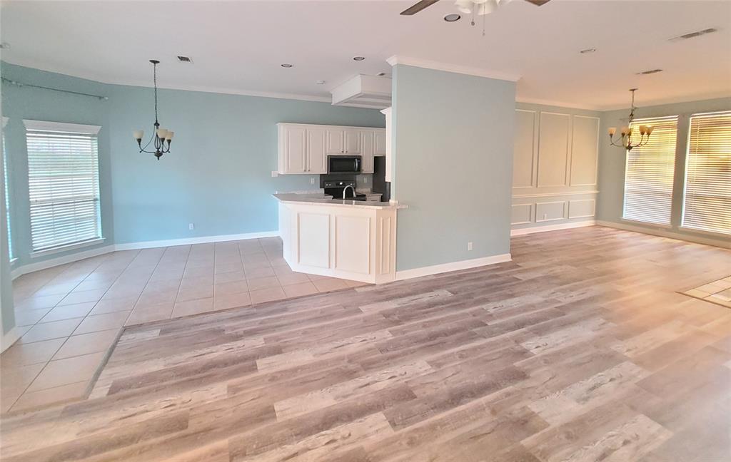 8921 Bontura Road Granbury, TX 76049 - Photo 6 of 26 a view of a kitchen with wooden floor and a sink