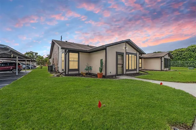 a backyard of a house with table and chairs