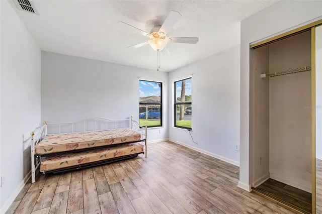 a spacious bedroom with a bed and a chandelier