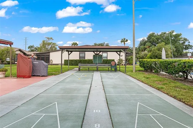 a view of a house with a yard and potted plants
