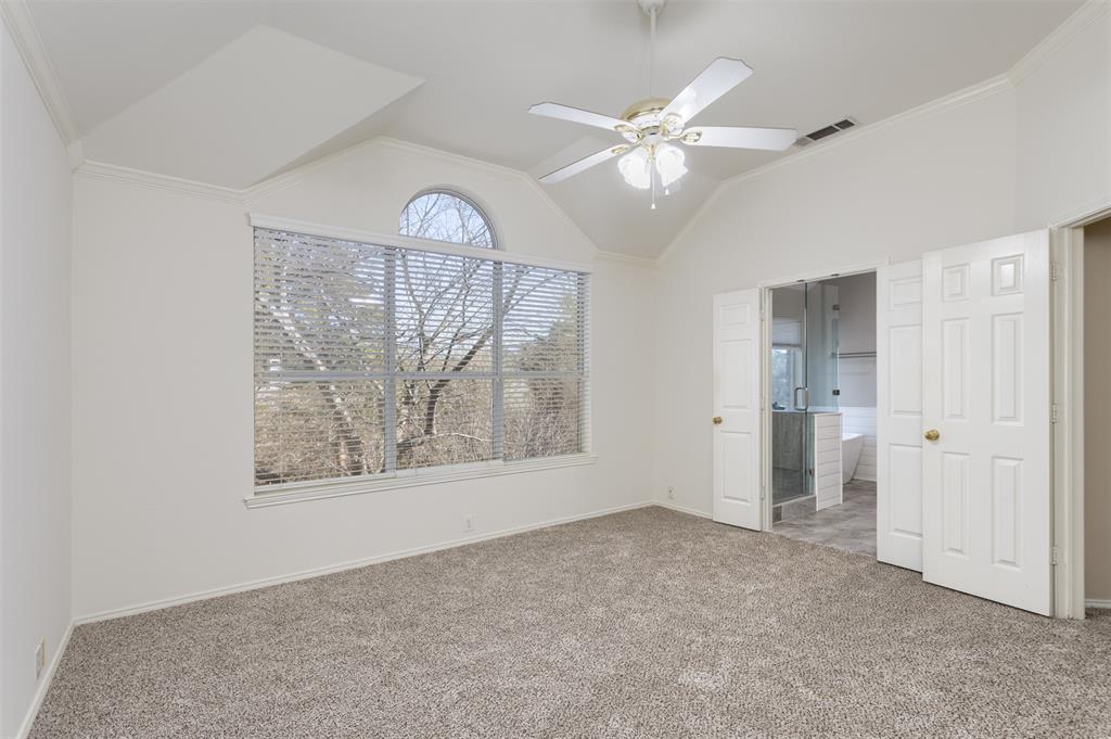 3306 Harbor Pointe Drive Rowlett, TX 75088 - Photo 20 of 40 Large picture window and views of woods, new carpet, ceiling fan and ensuite bath