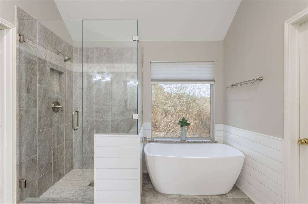 3306 Harbor Pointe Drive Rowlett, TX 75088 - Photo 21 of 40 Updated with frameless tiled shower and modern stand alone soaking tub overlooking the wooded backyard