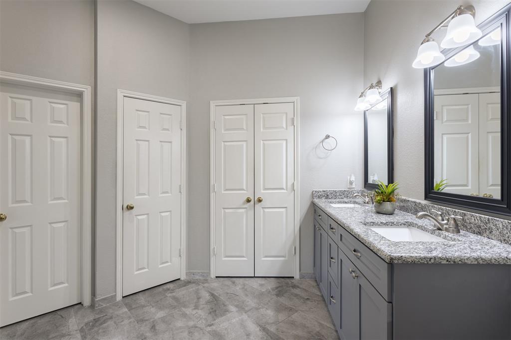 3306 Harbor Pointe Drive Rowlett, TX 75088 - Photo 22 of 40 Updated with granite dual sinks, tile and lighting; linen, toilet and oversized primary closet