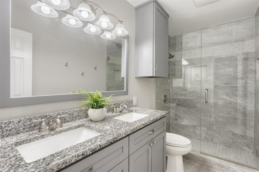 3306 Harbor Pointe Drive Rowlett, TX 75088 - Photo 25 of 40 Updated upstairs bath with granite vanity, toiletry cabinet, frameless glass shower