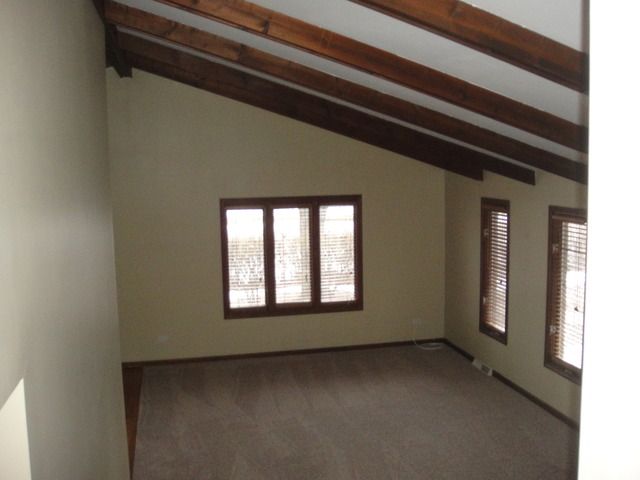 28W726 Wagner Road Naperville, IL 60564 - Photo 11 of 22 a view of a livingroom with an empty space and a window