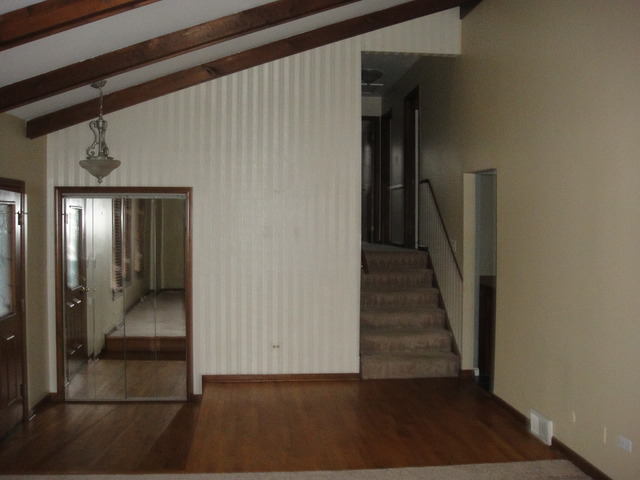 28W726 Wagner Road Naperville, IL 60564 - Photo 9 of 22 a view of a hallway with wooden floor and entryway