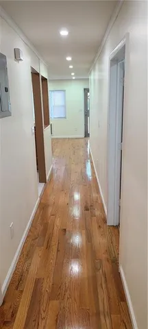 a view of hallway with wooden floor