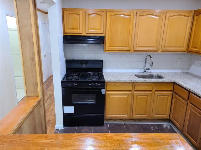 a kitchen with granite countertop cabinets stainless steel appliances and a sink