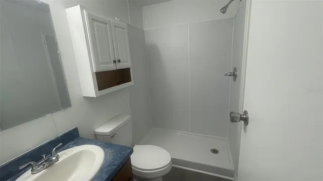 a bathroom with a toilet and a shower