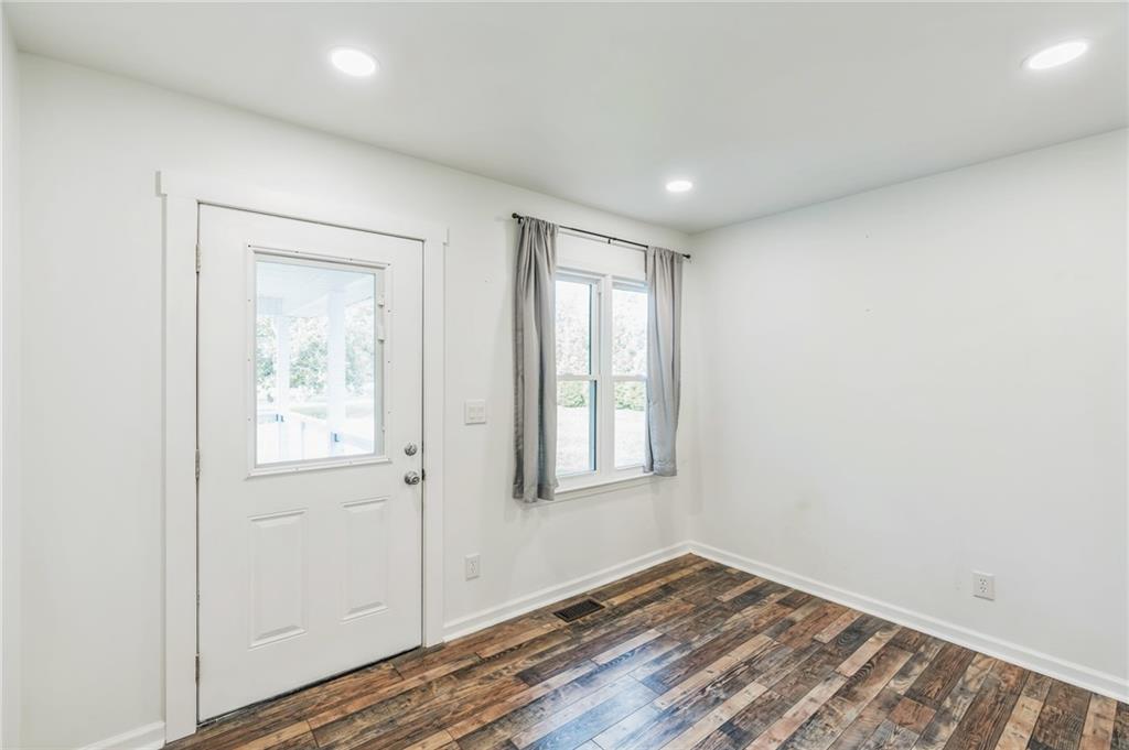 500 Coleman Mill Road Carrollton, GA 30116 - Photo 27 of 83 an empty room with wooden floor and windows