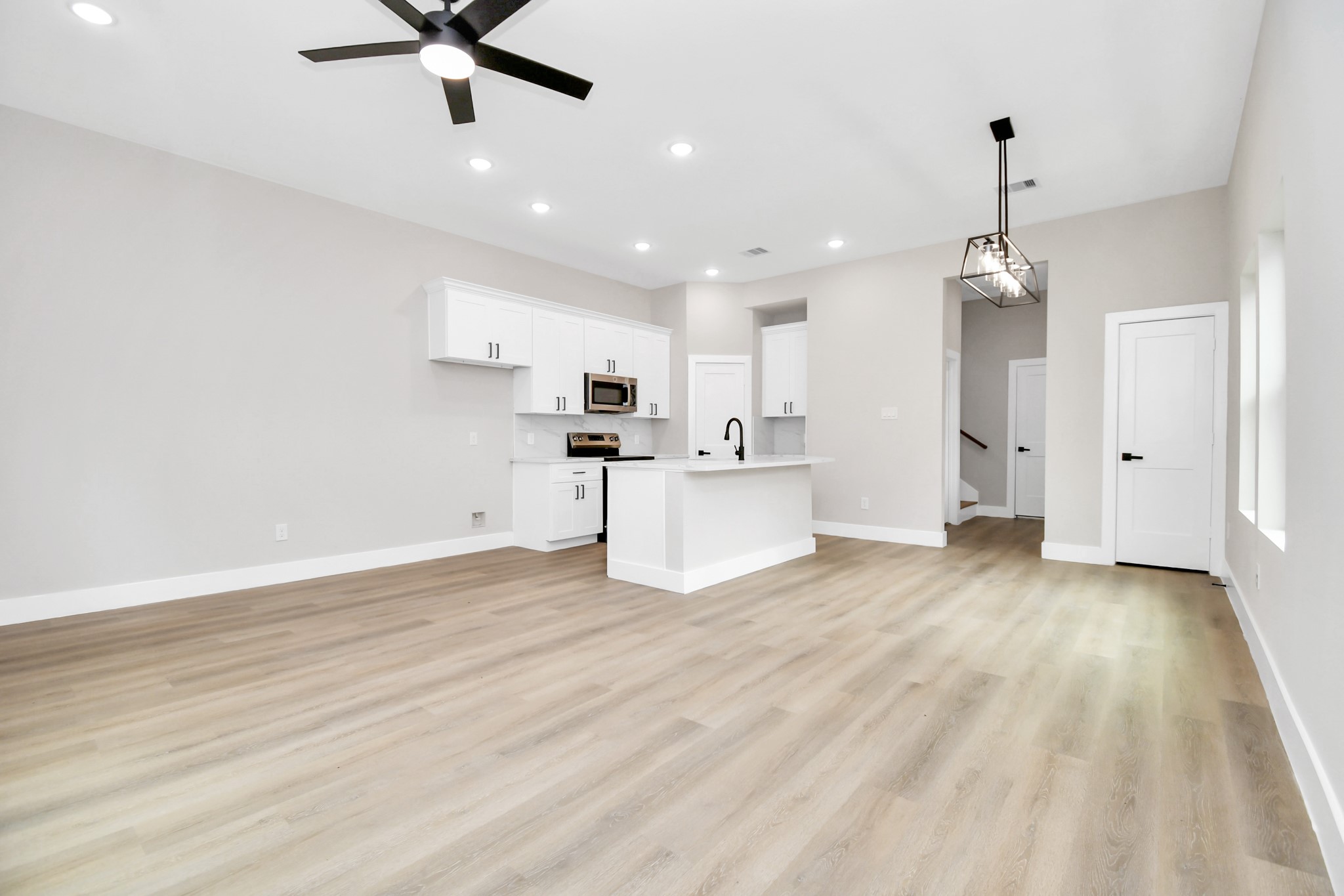 8409 Sunnyhill Street Houston, TX 77088 - Photo 3 of 13 a view of a kitchen with a sink and wooden floor
