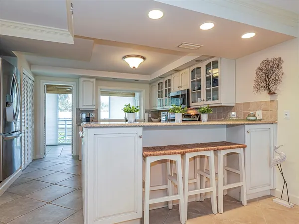 a kitchen with stainless steel appliances granite countertop a refrigerator and cabinets
