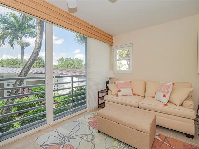 a living room with furniture a large window