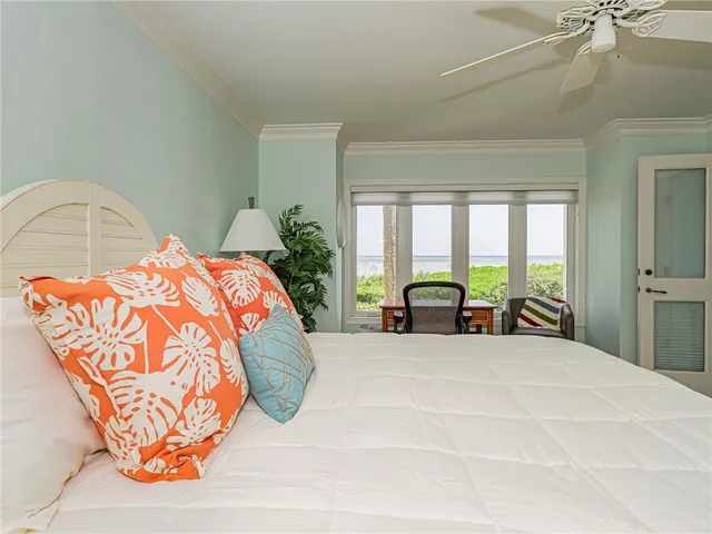 a large bed sitting in a bedroom next to a window
