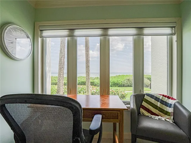 a bedroom with a large window and a bed