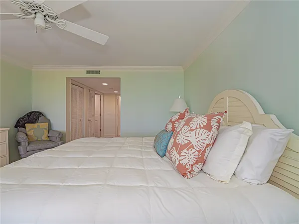 a bedroom with a bed and a lamp