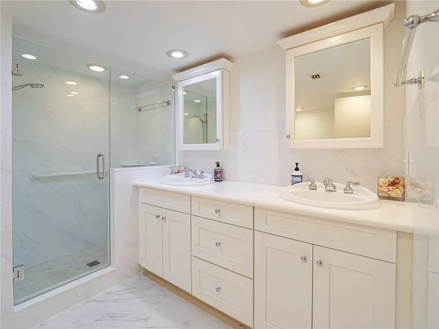 a bathroom with double sink and a mirror