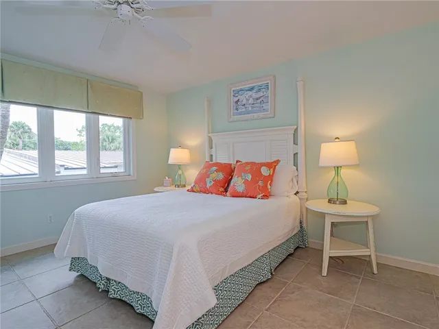 a bedroom with a bed and a lamp