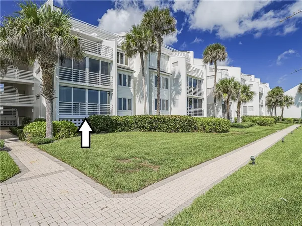a view of a building with a yard and many windows
