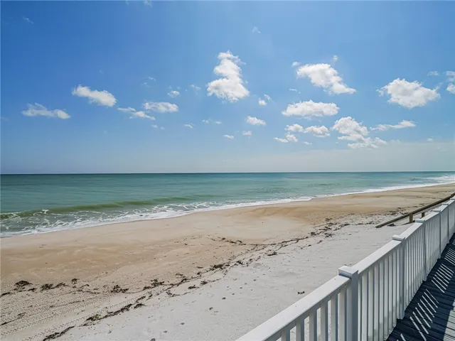 an aerial view of a house with a yard and lake view