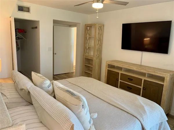 a bedroom with a bed and a flat screen tv