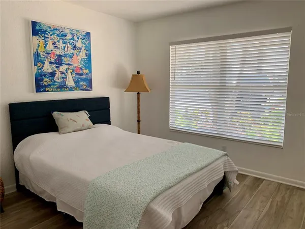 a bed sitting in a bedroom next to a window