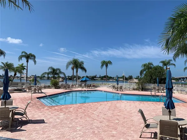 a view of a swimming pool and lounge chairs