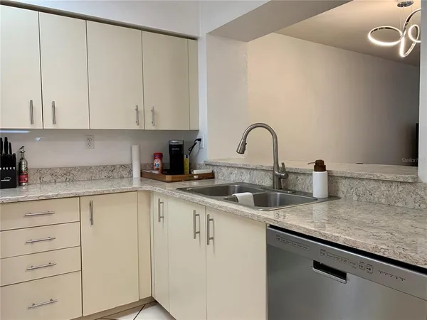 a kitchen with appliances a sink and cabinets