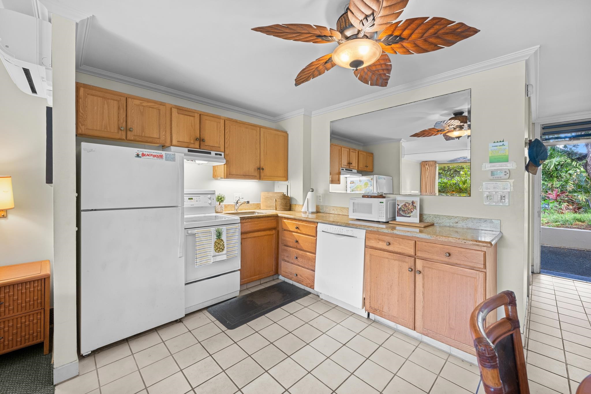 5315 Lower Honoapiilani Road, Unit D128 Lahaina, HI 96761 - Photo 5 of 24 a kitchen with a cabinets stainless steel appliances and a window