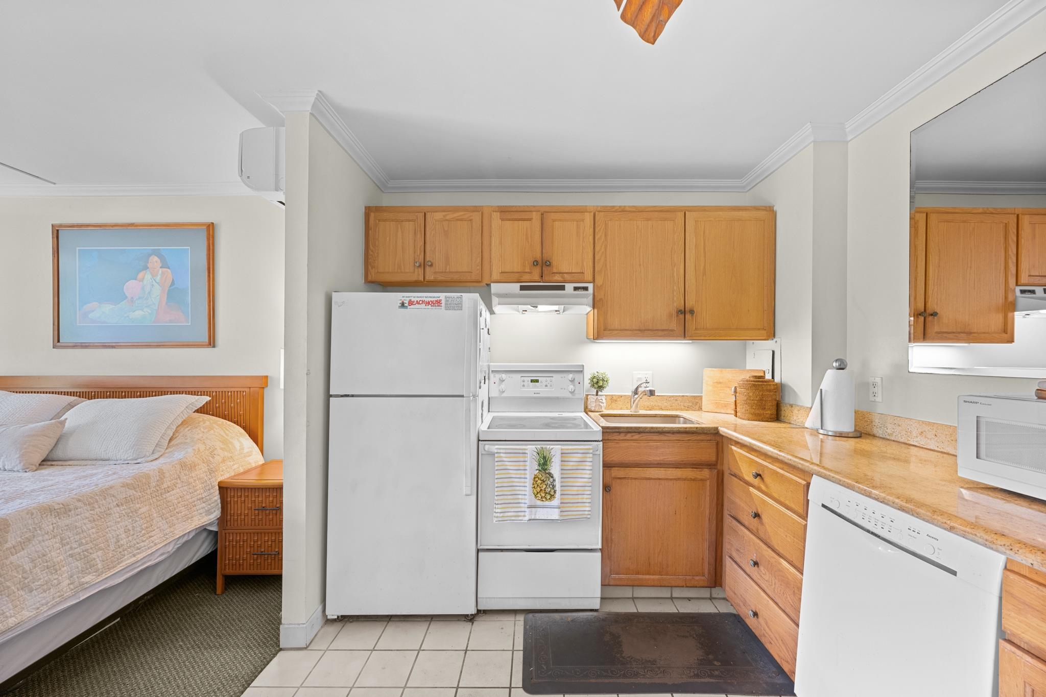 5315 Lower Honoapiilani Road, Unit D128 Lahaina, HI 96761 - Photo 6 of 24 a kitchen with a refrigerator sink and cabinets
