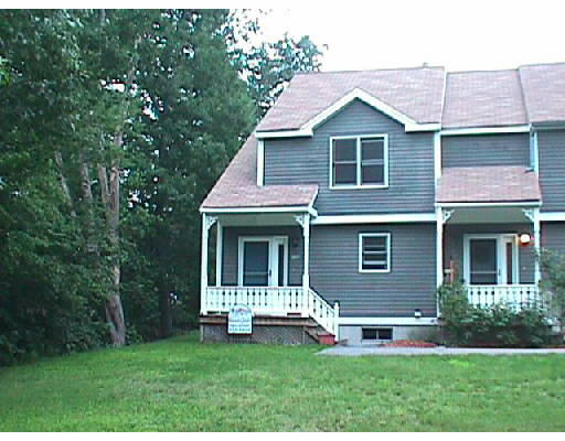 a front view of a house with a yard and porch