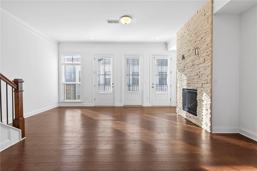 1752 Morningtide Lane Northeast Atlanta, GA 30324 - Photo 11 of 57 an empty room with wooden floor and fireplace